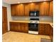 Warm kitchen with wooden cabinets, laminate countertops, and new appliances at 316 Elm St, Greenwood, IN 46142