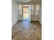 Sun room featuring a patterned tile floor, white brick walls, and ample windows at 316 Elm St, Greenwood, IN 46142