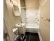 Compact bathroom featuring a shower-tub combo and a quirky toilet seat cover at 3426 W Michigan St, Indianapolis, IN 46222