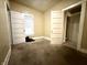 Bright bedroom with soft carpeting and multiple doors for easy access at 3426 W Michigan St, Indianapolis, IN 46222
