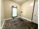 A simple bedroom features neutral walls and a window with sheer curtain at 3426 W Michigan St, Indianapolis, IN 46222