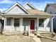 Charming home featuring a covered front porch and a striking red front door at 3426 W Michigan St, Indianapolis, IN 46222
