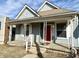 Charming home featuring a covered front porch and a striking red front door at 3426 W Michigan St, Indianapolis, IN 46222
