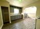 An open kitchen features gray cabinets, a sink, and appliances at 3426 W Michigan St, Indianapolis, IN 46222