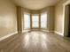 Bright living room featuring wood floors and a bay window for ample natural light at 3426 W Michigan St, Indianapolis, IN 46222