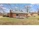 Backyard with grass, a brick patio, and lovely landscaping at 3779 W County Line Rd, Greenwood, IN 46142