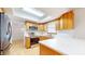 Well-lit kitchen featuring wooden cabinets, stainless steel appliances, and white countertops at 3779 W County Line Rd, Greenwood, IN 46142