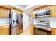 Modern kitchen featuring stainless steel appliances, wooden cabinetry, and ample countertop space at 3779 W County Line Rd, Greenwood, IN 46142