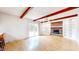 Bright living room boasts a brick fireplace, exposed wood beams, and sliding glass doors at 3779 W County Line Rd, Greenwood, IN 46142