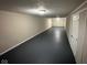 The basement is spacious and features a neutral color palette with sleek black floors at 3851 N Campbell Ave, Indianapolis, IN 46226