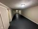 A partially finished basement space with fresh paint and new black floors at 3851 N Campbell Ave, Indianapolis, IN 46226