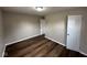 Comfortable bedroom featuring new dark wood flooring and neutral paint with closet at 3851 N Campbell Ave, Indianapolis, IN 46226