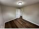 Bright bedroom featuring new dark wood flooring and neutral paint with closet at 3851 N Campbell Ave, Indianapolis, IN 46226