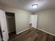 Cozy bedroom with closet, new dark wood flooring, and neutral paint at 3851 N Campbell Ave, Indianapolis, IN 46226