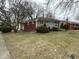 Side view of home featuring brick and stone accents and a well-maintained lawn at 3851 N Campbell Ave, Indianapolis, IN 46226