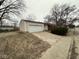 Detached two-car garage with concrete driveway in need of repair at 3851 N Campbell Ave, Indianapolis, IN 46226