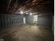 Spacious garage area with concrete flooring and exposed ceiling rafters at 3851 N Campbell Ave, Indianapolis, IN 46226