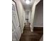 Hallway with new dark wood flooring and neutral paint leading to bedrooms at 3851 N Campbell Ave, Indianapolis, IN 46226