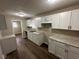 Bright kitchen featuring white cabinets, stainless steel sink, and granite countertops at 3851 N Campbell Ave, Indianapolis, IN 46226