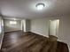 Spacious living room with new dark wood flooring, neutral walls, and ample natural light at 3851 N Campbell Ave, Indianapolis, IN 46226