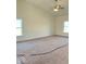 Large bedroom with neutral walls, carpet and ceiling fan. Two windows provide natural light at 3885 Berkdale Ct, Columbus, IN 47203