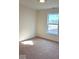 This bedroom has neutral walls, carpet, and a window letting in natural light at 3885 Berkdale Ct, Columbus, IN 47203