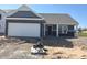 New construction featuring a brick and siding facade, an attached two-car garage and a covered front porch at 3885 Berkdale Ct, Columbus, IN 47203