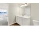 Bright bathroom featuring a white vanity, large mirror, and wood look floors at 3913 Wren Dr, Brownsburg, IN 46112