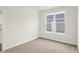 Bright bedroom with neutral carpet, white trim, and a large window at 3913 Wren Dr, Brownsburg, IN 46112