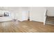Open-concept living area with hardwood floors connects the living room, kitchen and staircase at 3913 Wren Dr, Brownsburg, IN 46112