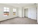Bright bedroom with neutral carpet and a closet, and large windows at 3959 Wren Dr, Brownsburg, IN 46112