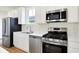 Modern kitchen features stainless steel appliances and white cabinets at 3959 Wren Dr, Brownsburg, IN 46112