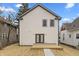 Exterior back of house with white siding, two windows, and double doors leading to a wood deck at 4054 Boulevard Pl, Indianapolis, IN 46208