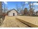 View of backyard with new deck and garage with fresh straw at 4054 Boulevard Pl, Indianapolis, IN 46208