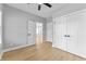 This bedroom features hardwood floors, ceiling fan, closet, and doors at 4054 Boulevard Pl, Indianapolis, IN 46208