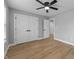 Bedroom features a ceiling fan, a closet, and multiple doorways, with hardwood floors at 4054 Boulevard Pl, Indianapolis, IN 46208