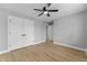 Spacious bedroom with a ceiling fan, a closet, and multiple doorways, with hardwood floors at 4054 Boulevard Pl, Indianapolis, IN 46208
