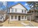 Charming two-story home featuring light-colored siding, gray accents, and a welcoming front porch at 4054 Boulevard Pl, Indianapolis, IN 46208