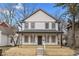 Charming two-story home featuring light-colored siding, gray accents, and a welcoming front porch at 4054 Boulevard Pl, Indianapolis, IN 46208