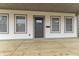 Covered front porch featuring a gray front door, wood decking, and white trim at 4054 Boulevard Pl, Indianapolis, IN 46208