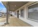 Welcoming front porch with wood decking, gray support posts, and recessed lighting at 4054 Boulevard Pl, Indianapolis, IN 46208
