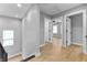 Second floor hallway features hardwood floors, gray walls, natural light, and multiple doorways at 4054 Boulevard Pl, Indianapolis, IN 46208