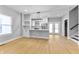 Modern kitchen featuring white cabinets, stainless steel appliances, and a stylish light fixture at 4054 Boulevard Pl, Indianapolis, IN 46208