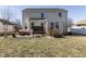 View of the backyard featuring a patio with outdoor seating and a grassy area at 4063 S Meadow Wood Ct, New Palestine, IN 46163