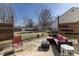 Cozy backyard patio featuring a modern outdoor seating area, mature trees, and a fenced yard at 4063 S Meadow Wood Ct, New Palestine, IN 46163
