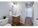 Well-lit half bathroom with wood-look floors and a vanity with a marble countertop at 4063 S Meadow Wood Ct, New Palestine, IN 46163