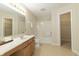 Bright bathroom with a large vanity, soaking tub with shower, and easy access to linen closet at 4063 S Meadow Wood Ct, New Palestine, IN 46163