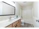 Bright bathroom featuring a shower-tub combo, wood vanity, and neutral wall paint at 4063 S Meadow Wood Ct, New Palestine, IN 46163