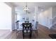 Cozy dining area with hardwood floors, chandelier, and views into the living room at 4063 S Meadow Wood Ct, New Palestine, IN 46163