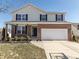 Two-story home with brick and siding exterior, black shutters, and a two-car garage at 4063 S Meadow Wood Ct, New Palestine, IN 46163